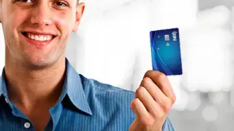 Hombre sonriente mostrando una tarjeta BN azul, simbolizando confianza y satisfacción con servicios financieros.