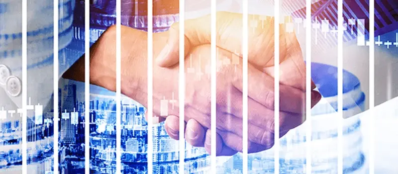 Apretón de manos sobre un fondo con gráficos financieros y barras de crecimiento.