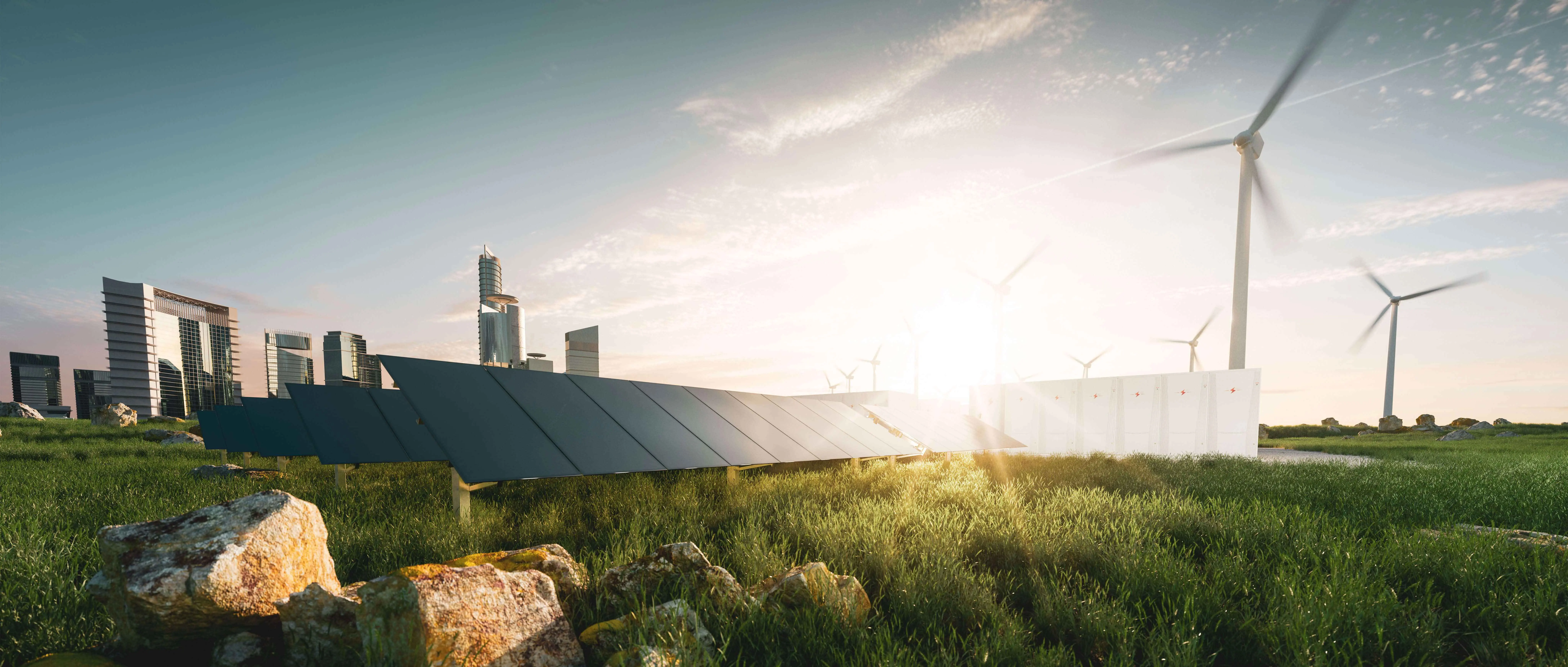 Paneles solares y aerogeneradores instalados en un campo verde, con edificios modernos al fondo y el sol brillando al atardecer.