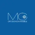 Logotipo de MG Ortodoncia Invisible en color blanco sobre fondo azul