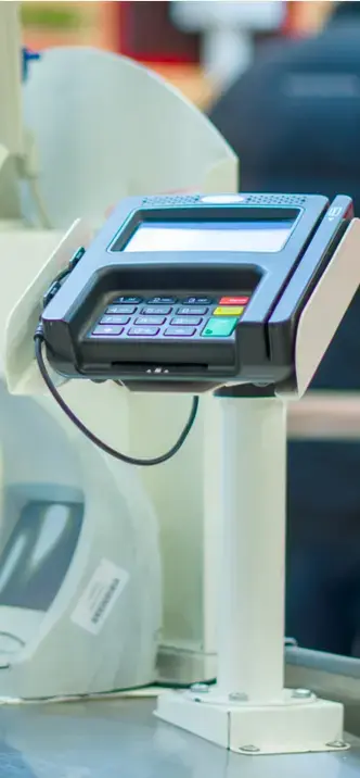 Terminal de pago electrónico (datáfono) montada sobre soporte en un punto de venta.